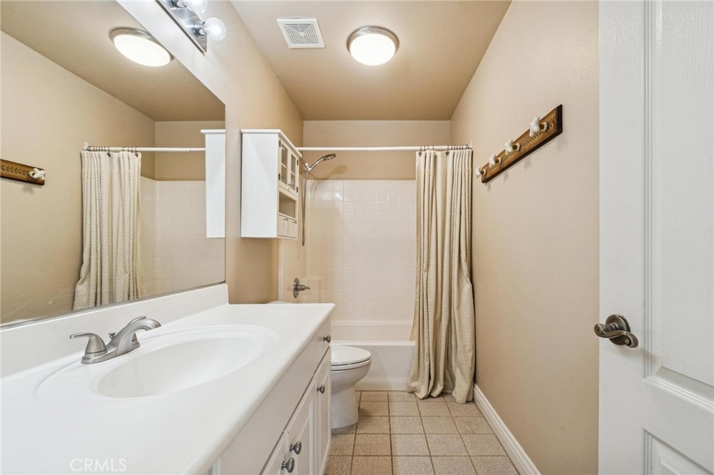 26511 Brooks Circle Stevenson Ranch, CA 91381 - Photo 35 of 65 a bathroom with a sink a toilet a mirror and shower