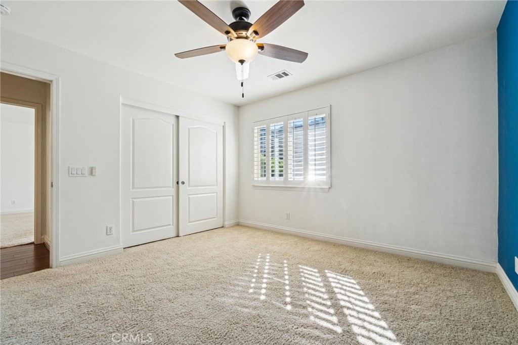 26511 Brooks Circle Stevenson Ranch, CA 91381 - Photo 41 of 65 an empty room with windows and fan