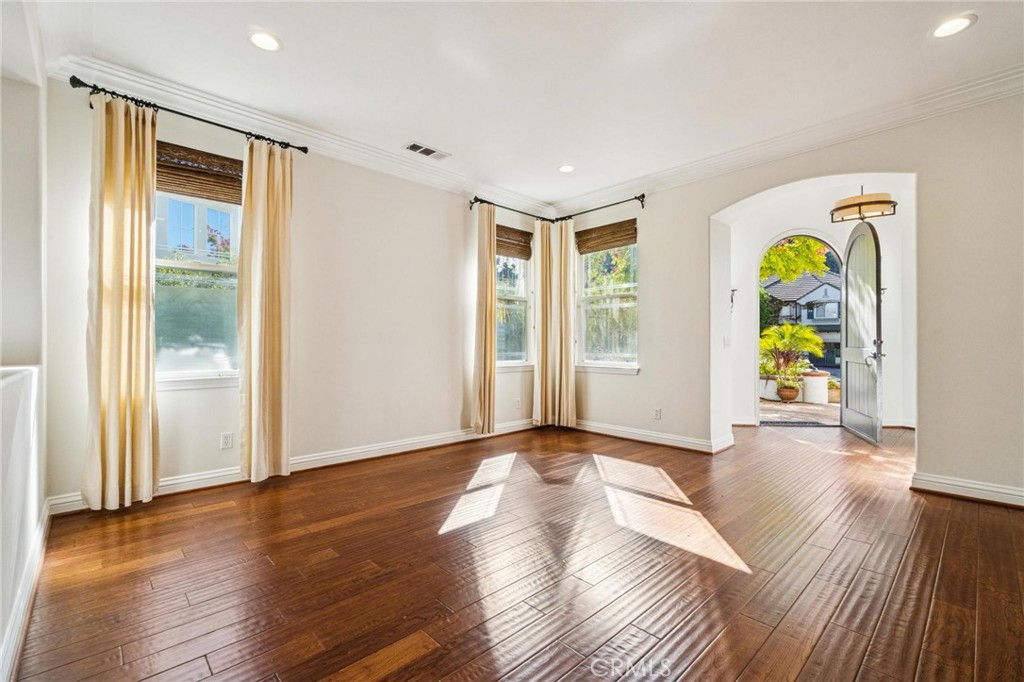 26511 Brooks Circle Stevenson Ranch, CA 91381 - Photo 6 of 65 a view of an empty room with wooden floor and a window