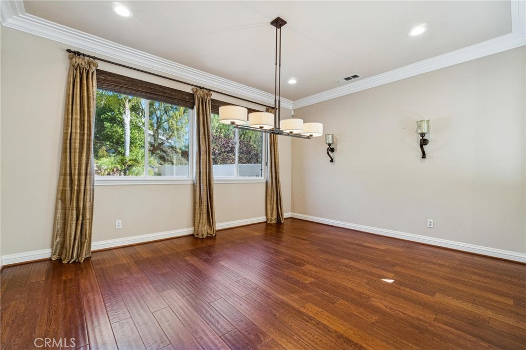 26511 Brooks Circle Stevenson Ranch, CA 91381 - Photo 8 of 65 a view of an empty room with wooden floor and a window