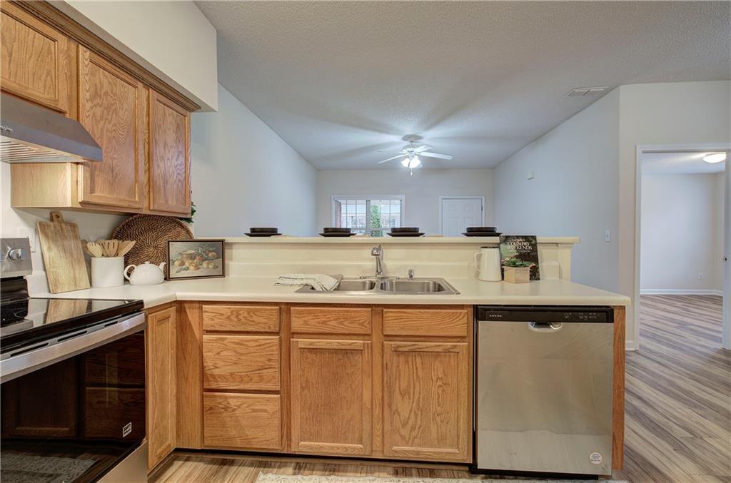 150 Old Mill Road, Unit 205 Cartersville, GA 30120 - Photo 15 of 32 a kitchen with granite countertop a sink and cabinets