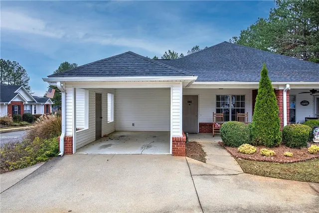 a front view of a house with a garden