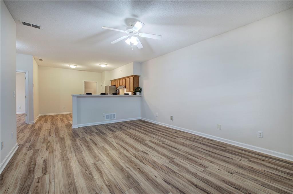 150 Old Mill Road, Unit 205 Cartersville, GA 30120 - Photo 4 of 32 a view of kitchen and empty room with wooden floor