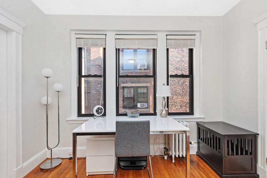 62 Queensberry Street, Unit 407 Boston, MA 02215 - Photo 6 of 14 a view of a dining room with furniture window and wooden floor
