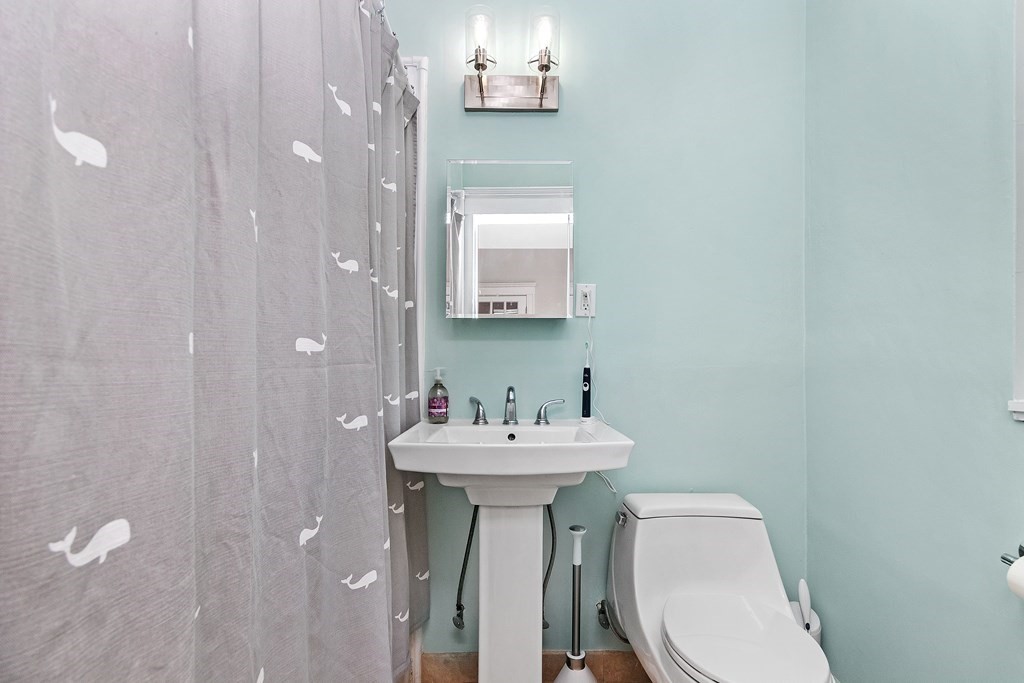 62 Queensberry Street, Unit 407 Boston, MA 02215 - Photo 7 of 14 a bathroom with a sink mirror and toilet