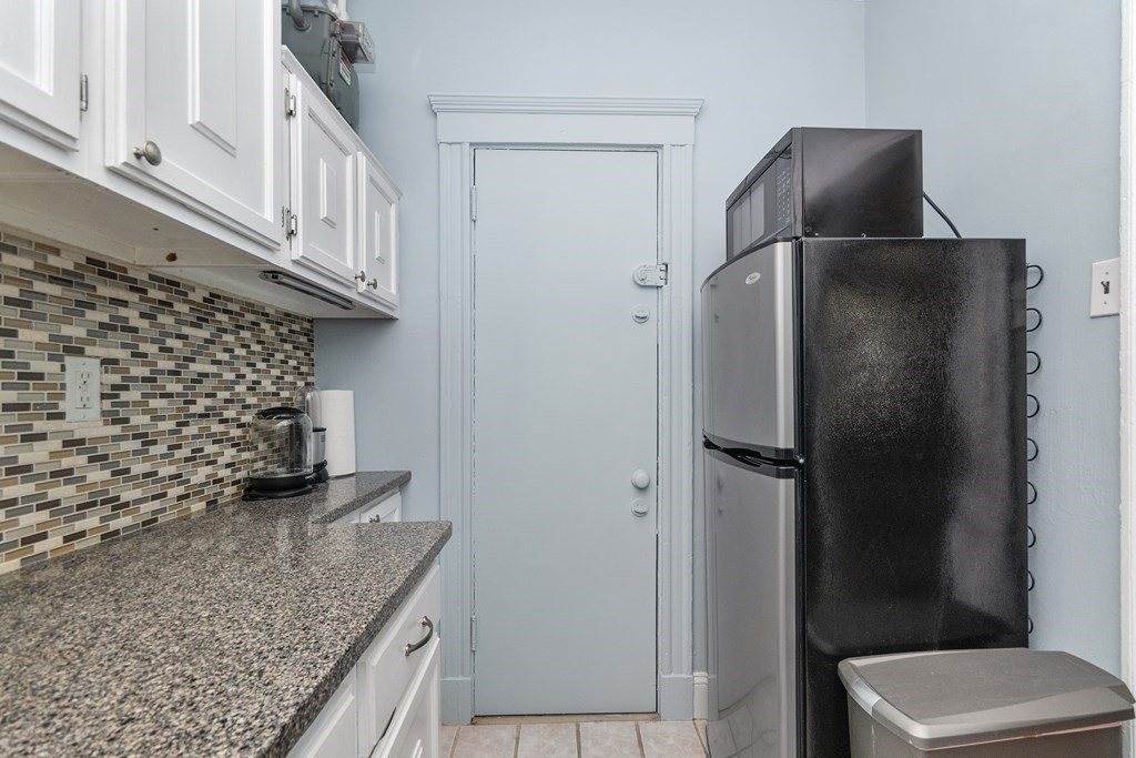 62 Queensberry Street, Unit 407 Boston, MA 02215 - Photo 10 of 14 a kitchen with a granite countertop refrigerator and sink