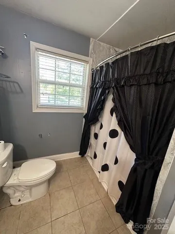 a bathroom with a sink mirror vanity and toilet