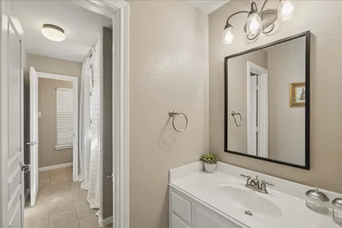 a bathroom with a sink a mirror and a shower