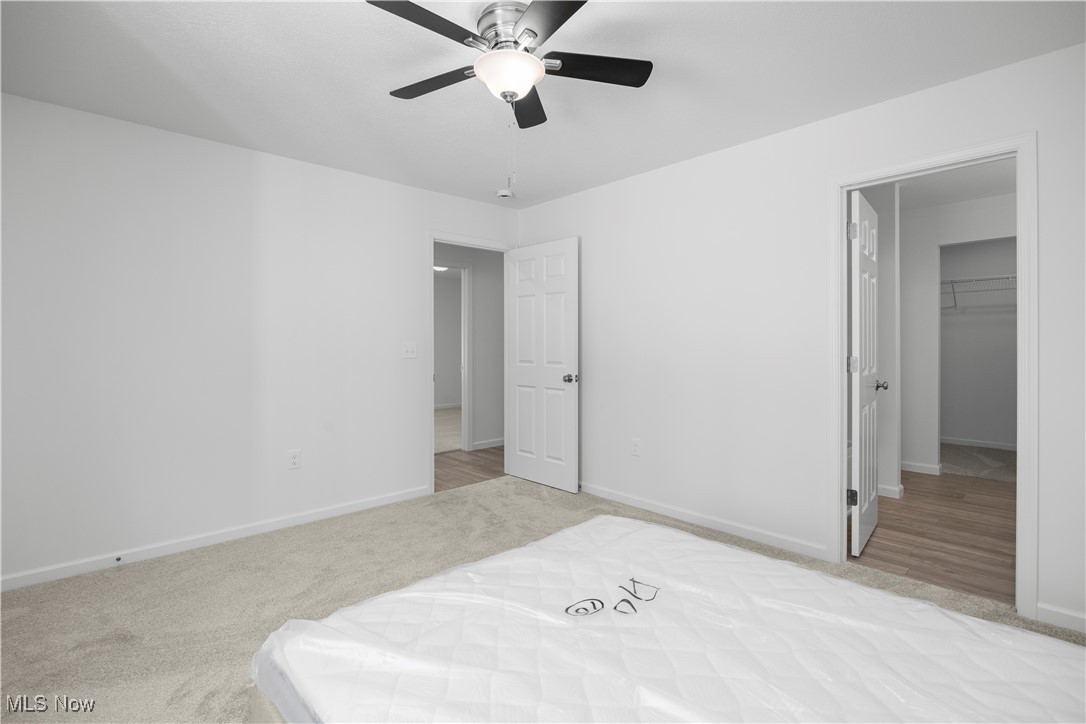 1999 East Oldgate Road Sandusky, OH 44870 - Photo 20 of 32 Bedroom featuring light colored carpet, a spacious closet, and ceiling fan
