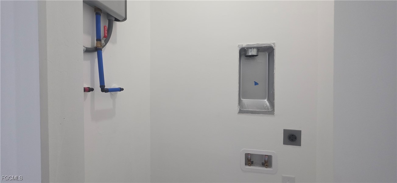 925 Chenault Street Lehigh Acres, FL 33974 - Photo 12 of 16 a bathroom with a shower