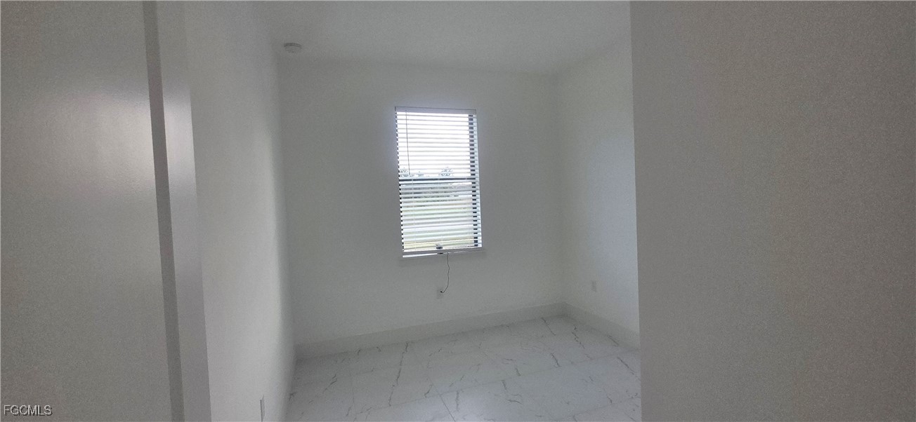 925 Chenault Street Lehigh Acres, FL 33974 - Photo 15 of 16 a view of an empty room with a window