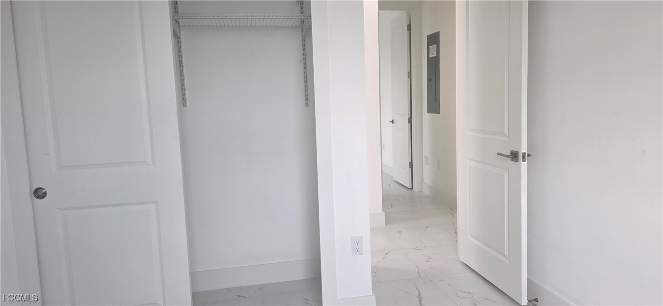925 Chenault Street Lehigh Acres, FL 33974 - Photo 16 of 16 a view of a bathroom from a hallway