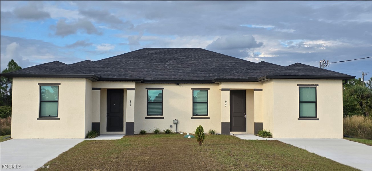 925 Chenault Street Lehigh Acres, FL 33974 - Photo 2 of 16 a front view of a house