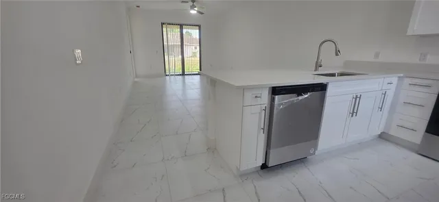 a view of an empty room with closet and a window