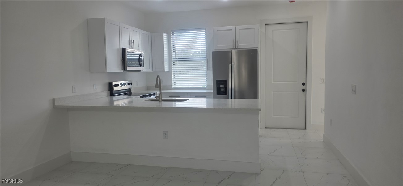 925 Chenault Street Lehigh Acres, FL 33974 - Photo 6 of 16 a bathroom with a sink and a mirror