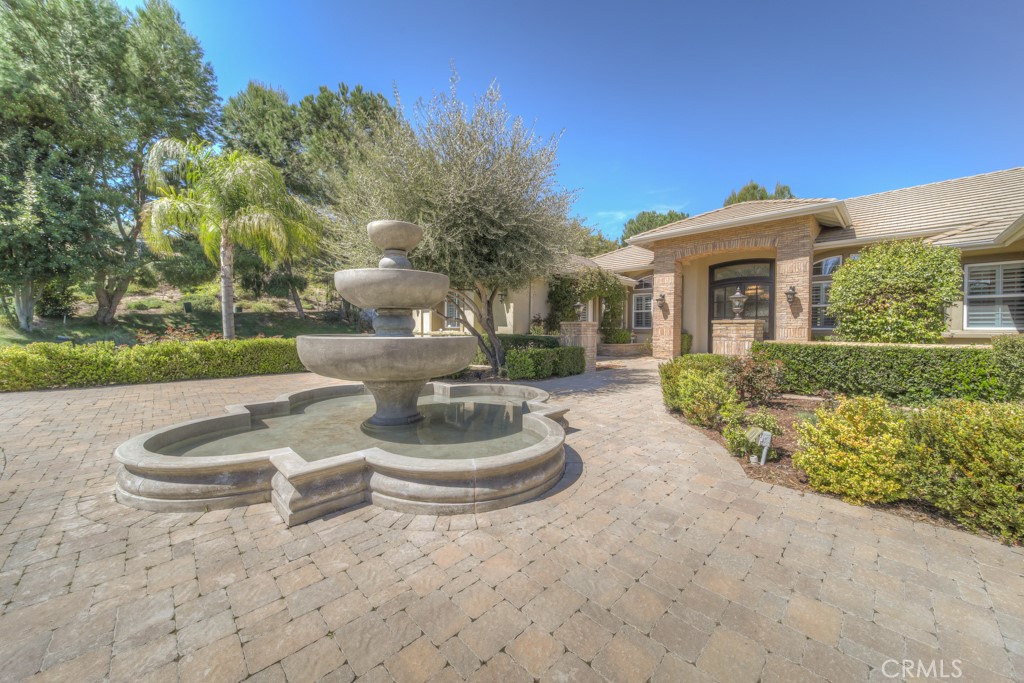 30370 Vía El Delora Temecula, CA 92592 - Photo 2 of 75 a front view of a house with a yard and fountain