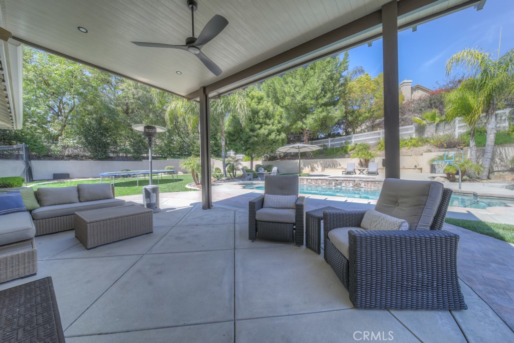 30370 Vía El Delora Temecula, CA 92592 - Photo 60 of 75 a living room with patio furniture and a floor to ceiling window