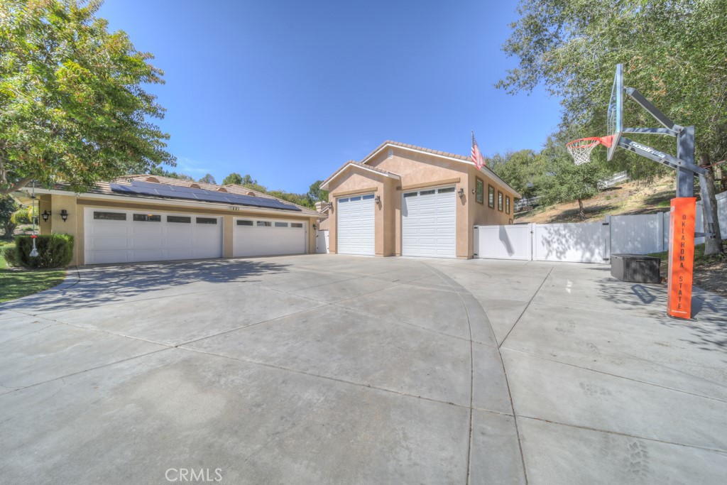 30370 Vía El Delora Temecula, CA 92592 - Photo 71 of 75 a view of a house with a large tree and a yard