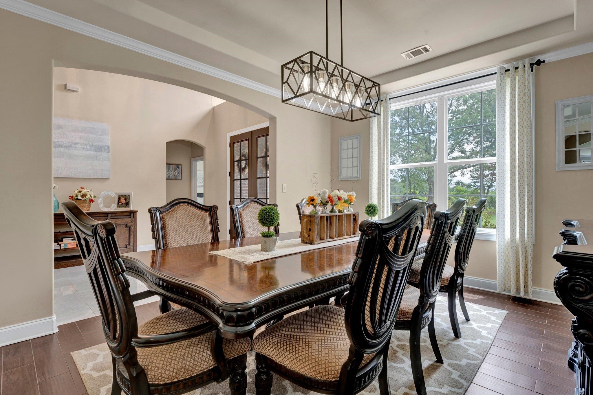 3270 Rast Road Millington, TN 38053 - Photo 1 of 40 Dining space featuring arched walkways, dark wood-style floors, crown molding, and french doors