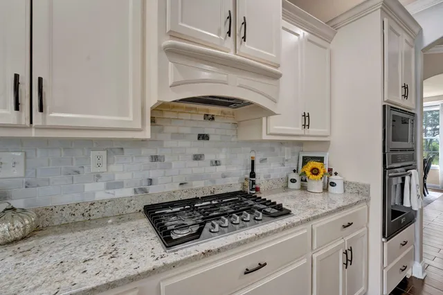 a stove top oven sitting inside of a kitchen