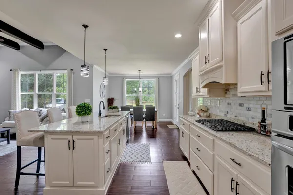 a kitchen with sink stove and cabinets