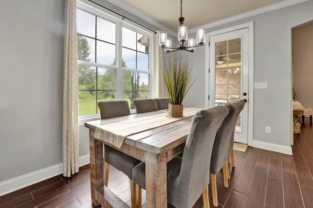 a view of a dining room with furniture window and wooden floor