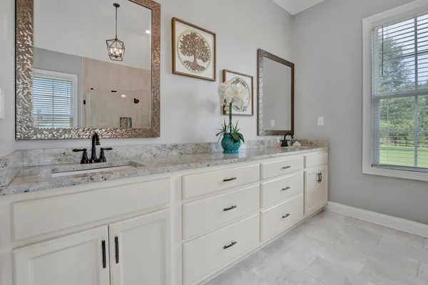 a bathroom with double sink and a mirror