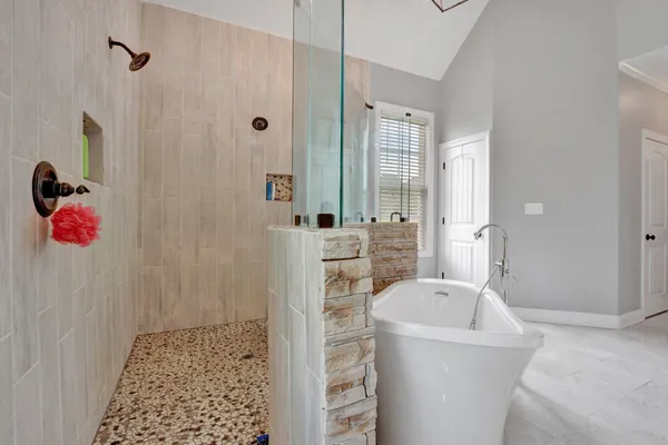 a bathroom with a tub sink and shower