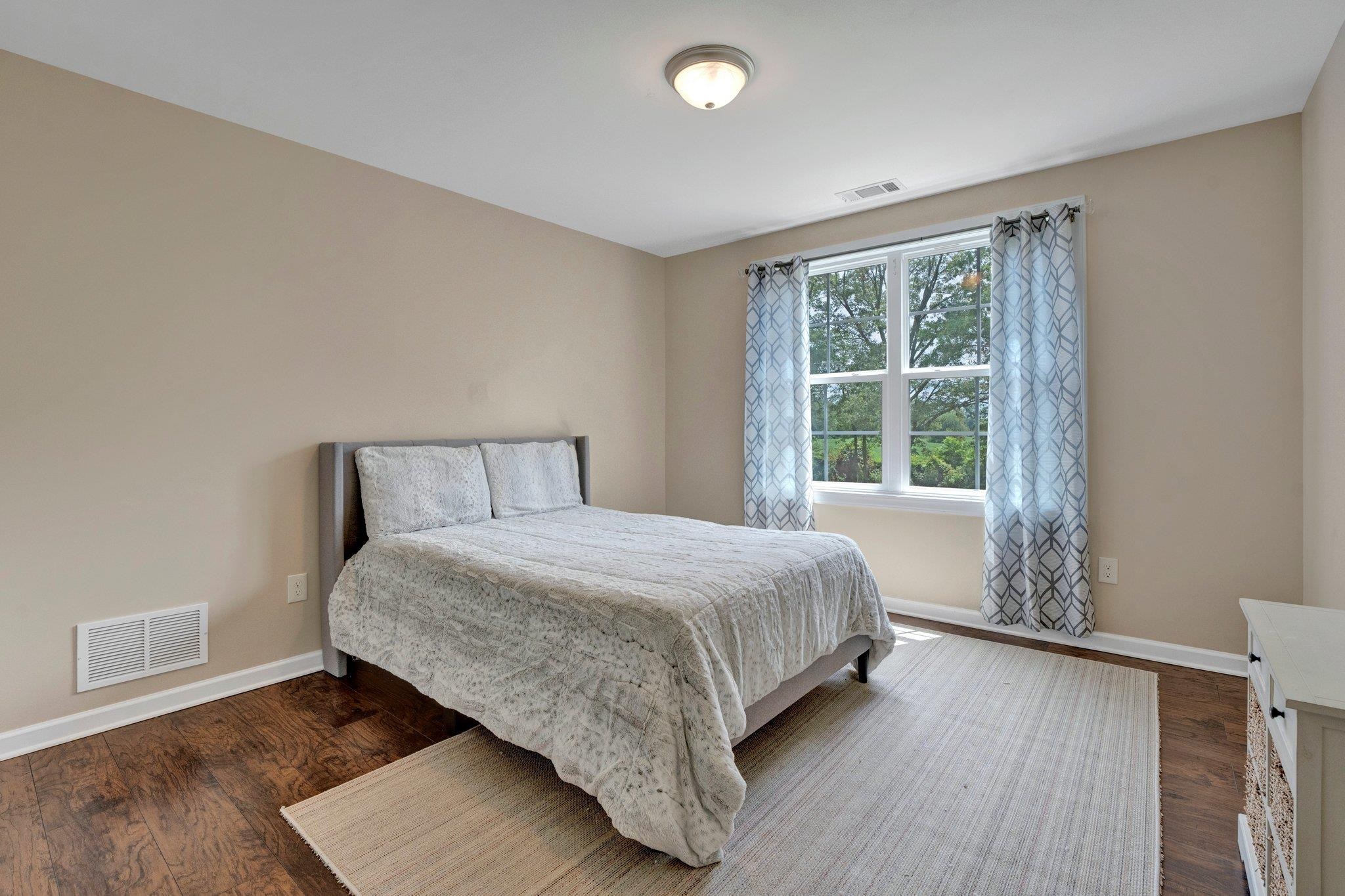 3270 Rast Road Millington, TN 38053 - Photo 34 of 40 a bedroom with a bed and wooden floor