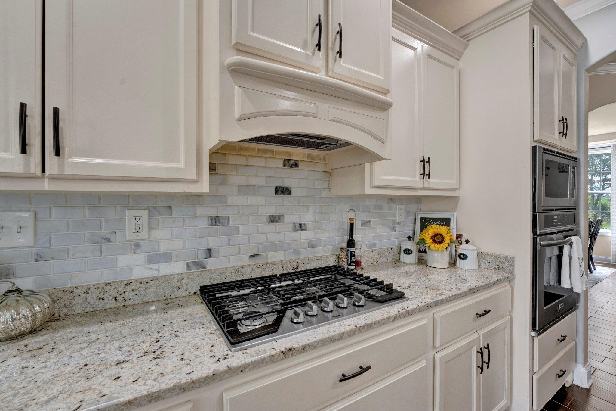 3270 Rast Road Millington, TN 38053 - Photo 9 of 40 Kitchen featuring light stone countertops, white cabinetry, appliances with stainless steel finishes, and tasteful backsplash
