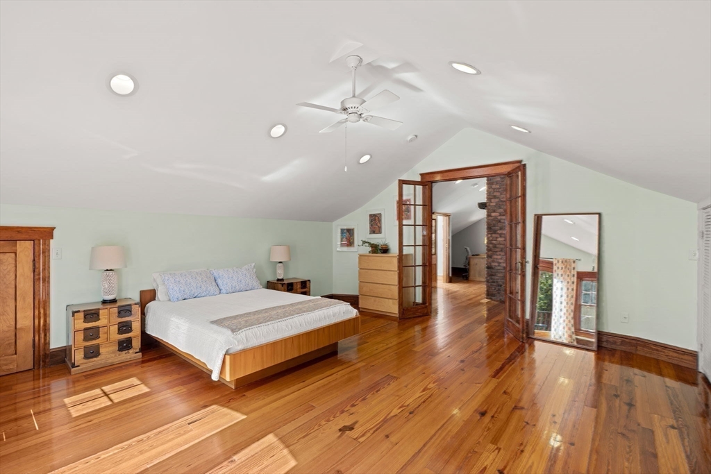 177 Highland Road Andover, MA 01810 - Photo 24 of 37 a spacious bedroom with a bed and a wooden floor