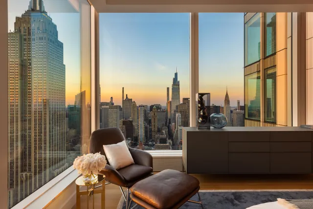 a living room with furniture and a floor to ceiling window