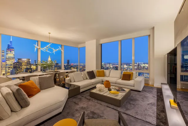 a living room with furniture a rug and a flat screen tv