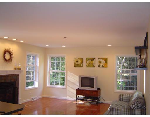 161 Rice Corner Road Brookfield, MA 01506 - Photo 15 of 28 a living room with furniture a fireplace and a large window