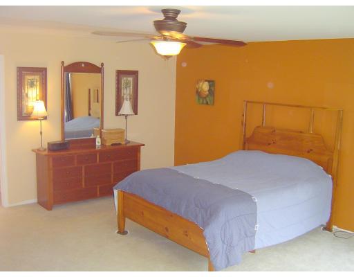 161 Rice Corner Road Brookfield, MA 01506 - Photo 18 of 28 a bedroom with a bed and dresser with mirror