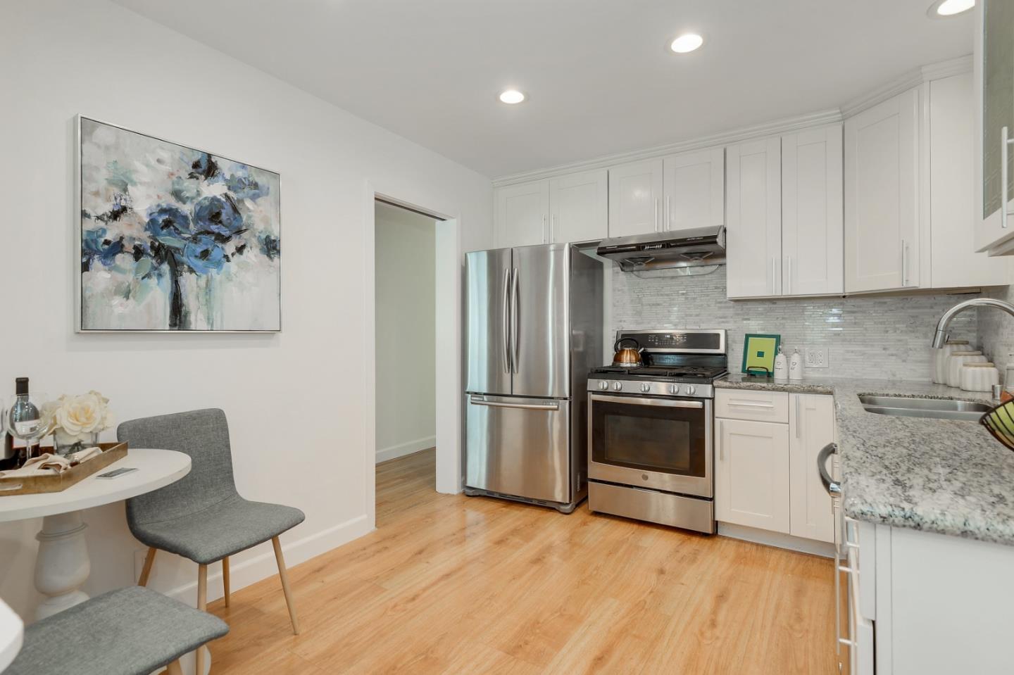 2576 Forest Avenue San Jose, CA 95050 - Photo 6 of 18 a kitchen with granite countertop a refrigerator and a stove top oven