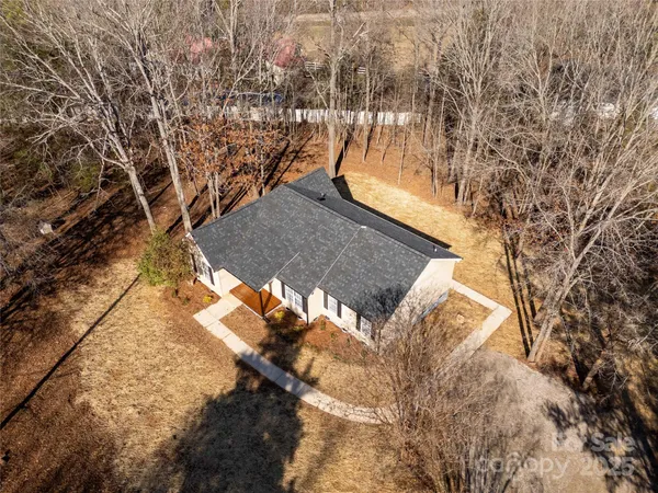 an aerial view of a house with yard and garage