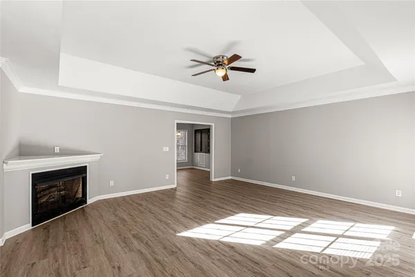 a large kitchen with stainless steel appliances granite countertop a stove and a wooden floors