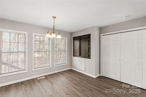 a kitchen with stainless steel appliances a stove and a wooden floors