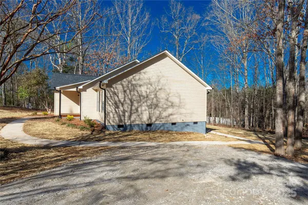 a view of a house with snow on the road