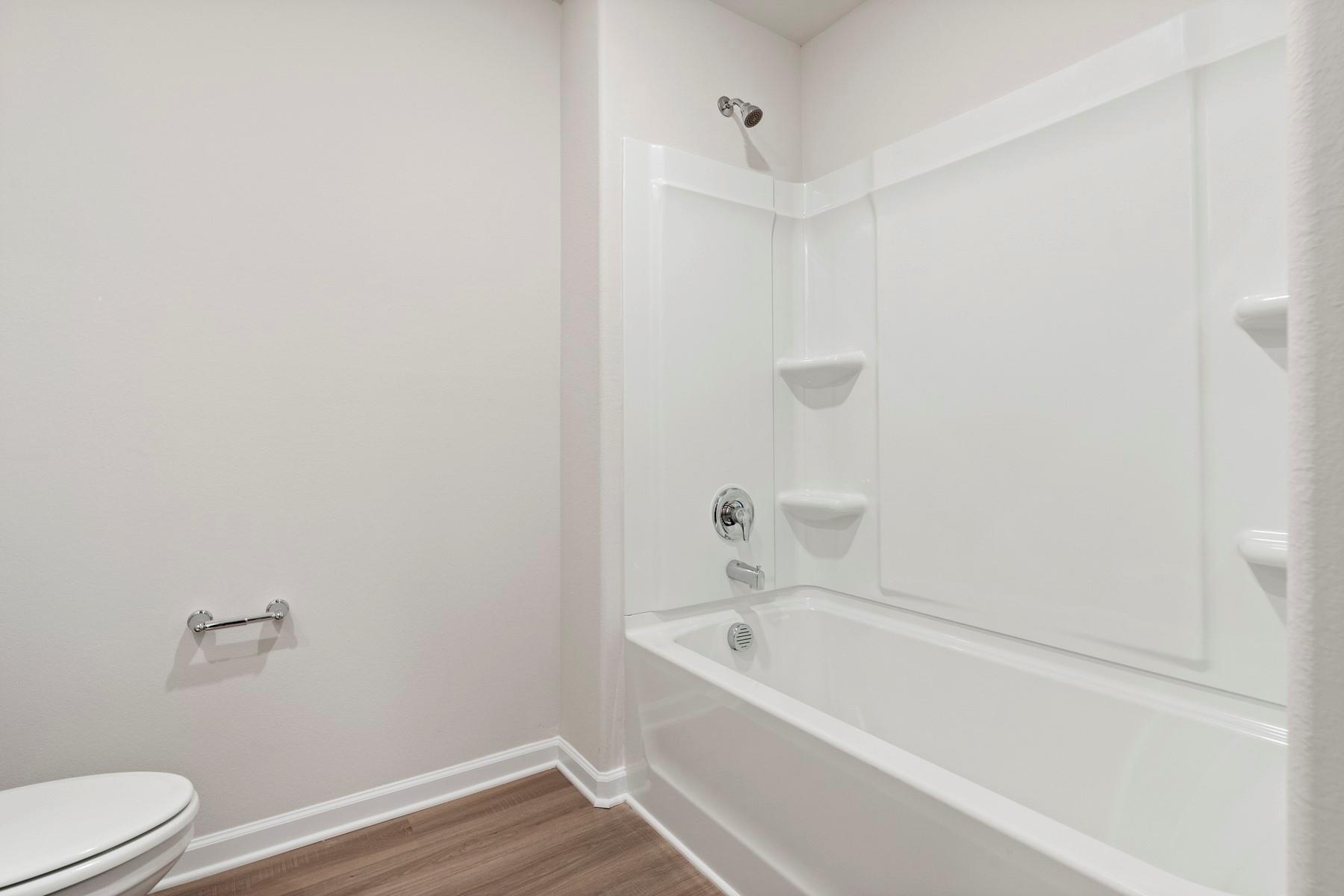 1405 Nia Road Charlotte, NC 28215 - Photo 16 of 16 a bathroom with a bathtub and toilet