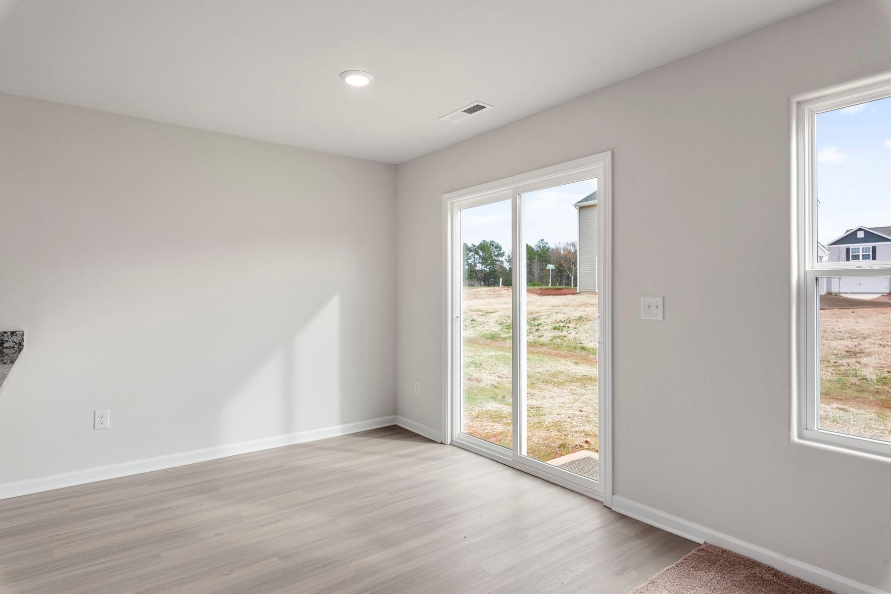 1405 Nia Road Charlotte, NC 28215 - Photo 6 of 16 an empty room with wooden floor and windows