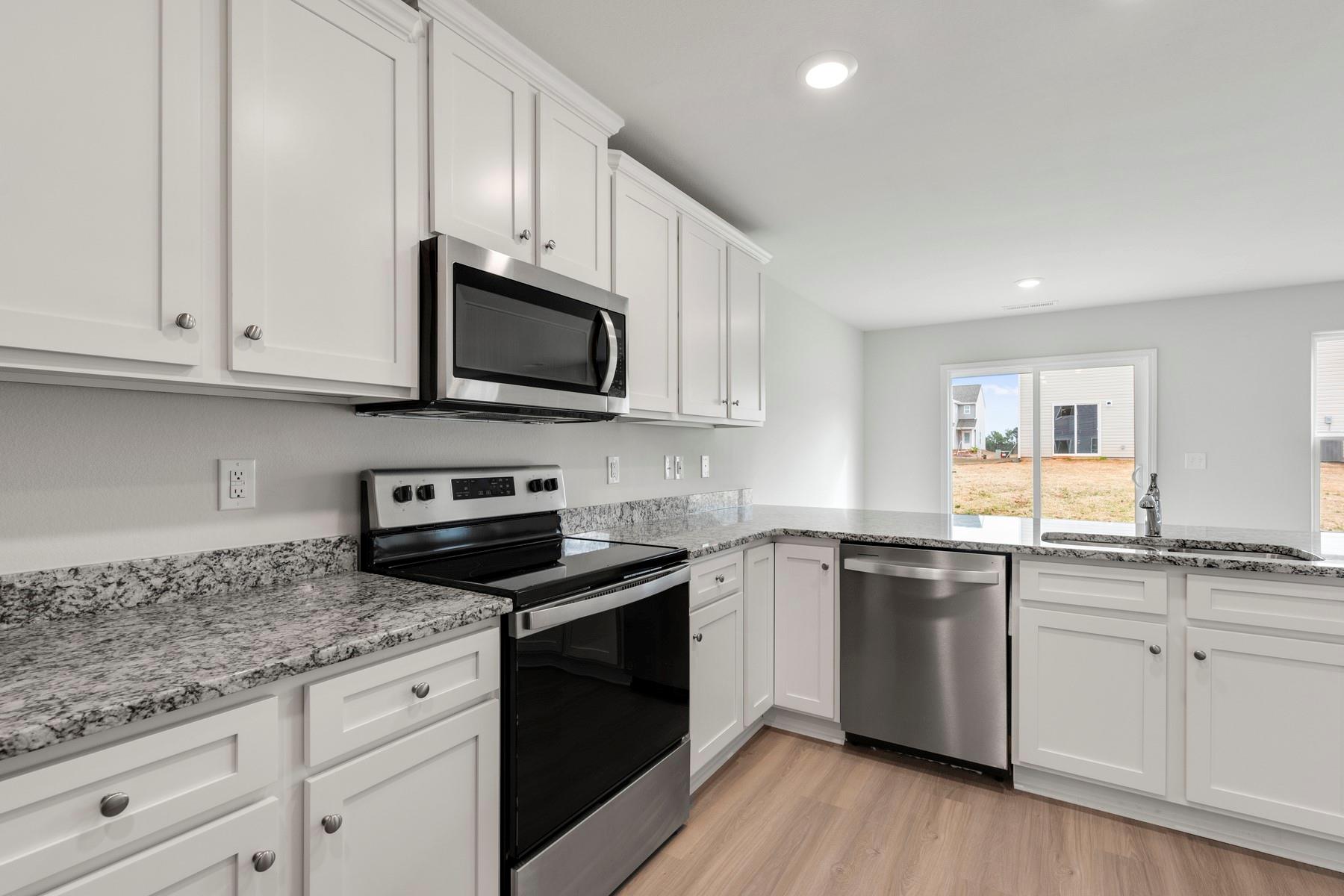 1405 Nia Road Charlotte, NC 28215 - Photo 10 of 16 a kitchen with granite countertop cabinets stainless steel appliances and a sink