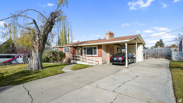 359 East 8400th Street South Sandy, UT 84070 - Photo 3 of 35 Ranch-style home featuring concrete driveway, a front lawn, a chimney, a carport, and a shingled roof