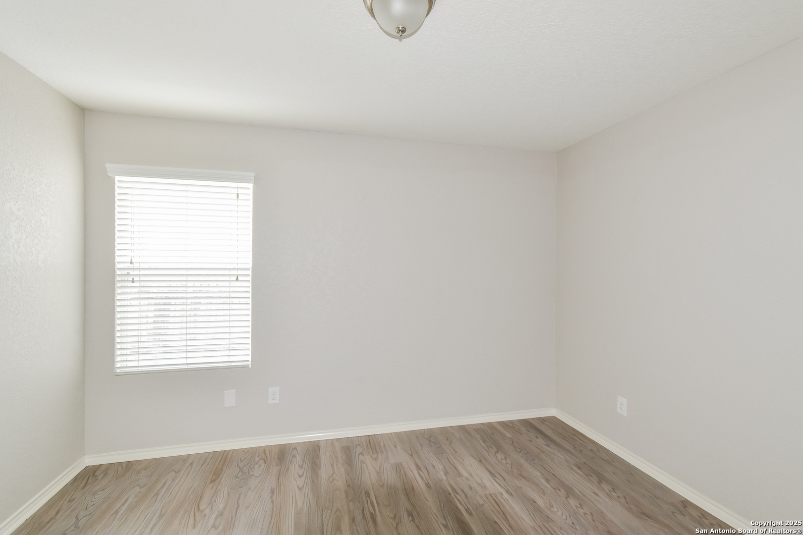 3603 Alonzo Fields Converse, TX 78109 - Photo 12 of 16 a view of an empty room with wooden floor and a window