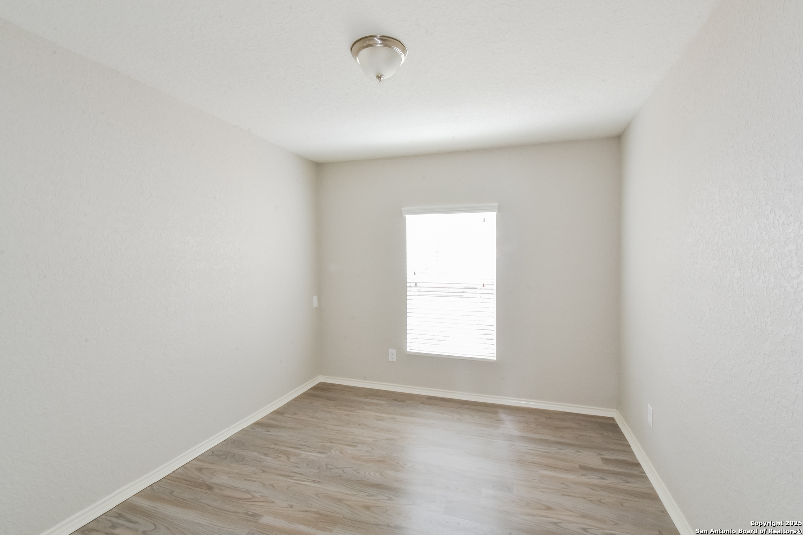 3603 Alonzo Fields Converse, TX 78109 - Photo 13 of 16 an empty room with wooden floor and windows