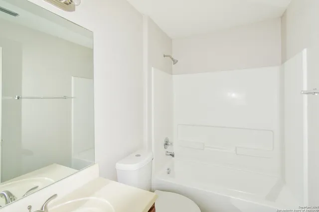 a bathroom with a bathtub and a toilet