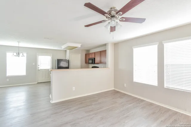 a view of a kitchen with an empty space and a window