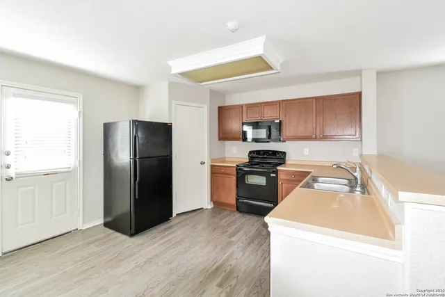 a kitchen with a refrigerator sink and microwave