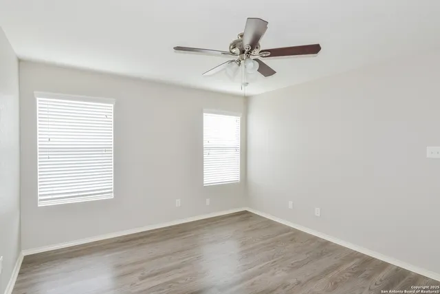 a view of a room with wooden floor and windows